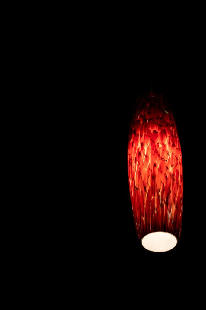 A stylish red lantern illuminating darkness with warm, soothing light.